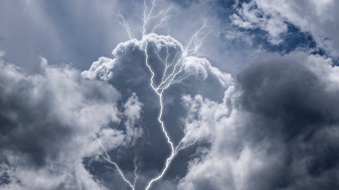 Branching lightning bolt striking through dark, dramatic storm clouds.