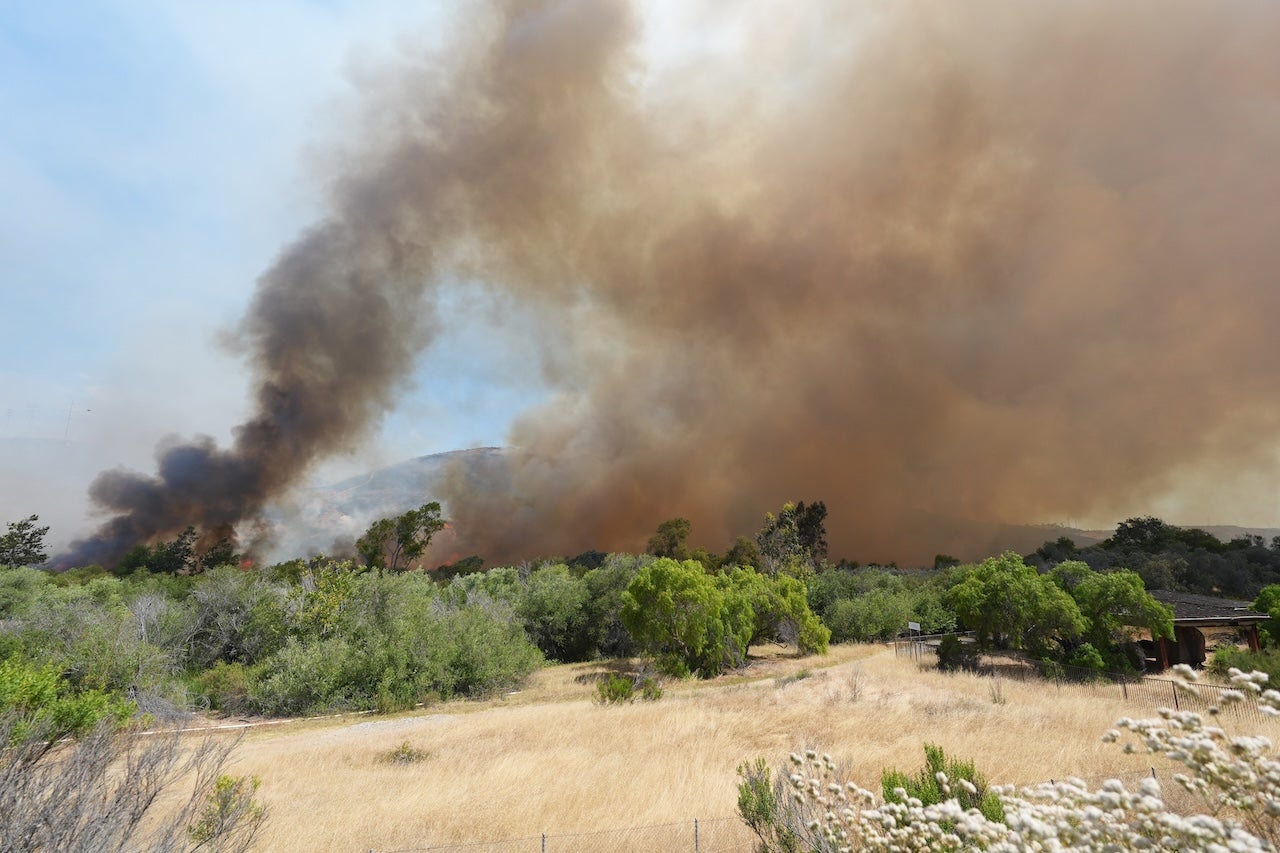 Smoke billows over Sorrento Valley as firefighters battle the fast-moving Sorrento Fire near the Interstate 5 and Interstate 805 interchange in San Diego, California, on June 08, 2026.