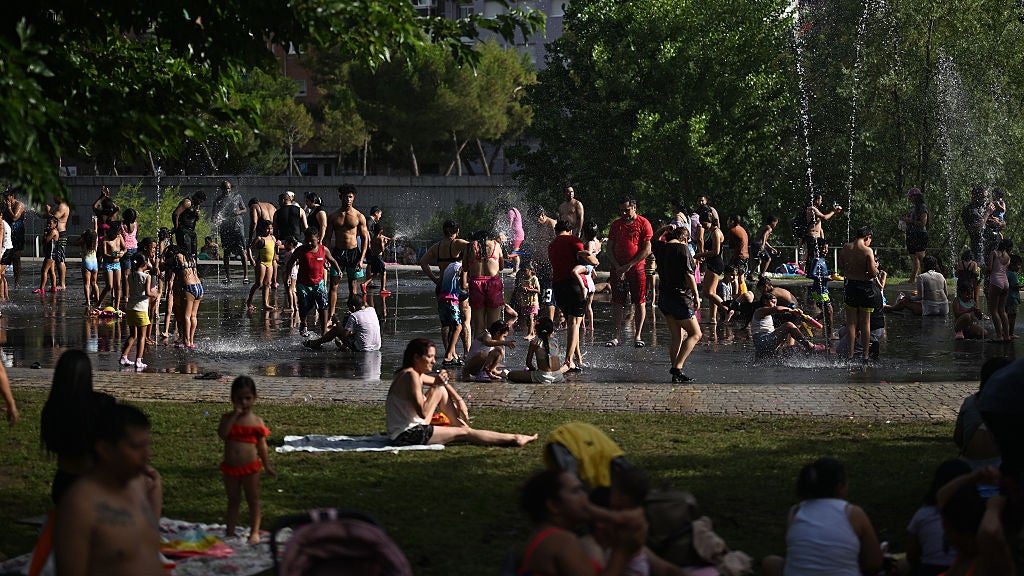people seek heat relief along the water