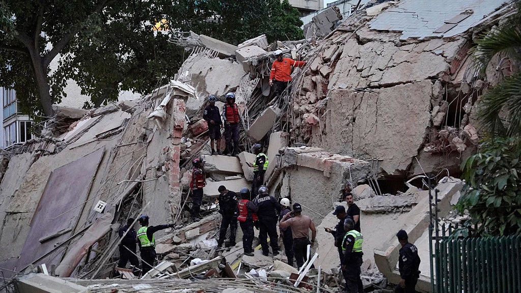 Rescuers search for victims in a collapsed building following an earthquake in Caracas on June 24, 2026. 