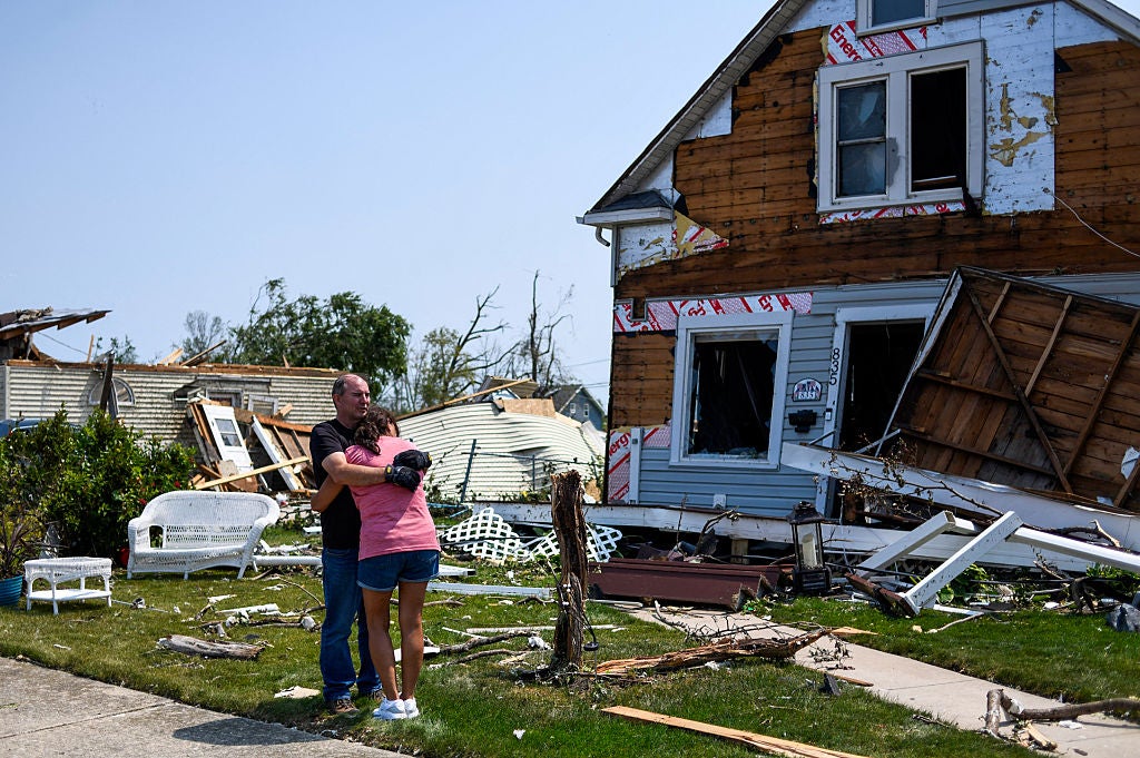 Residents react as they assess the damage of their property a day after a tornado ripped through Menasha, Wisconsin, on July 28, 2026. 
