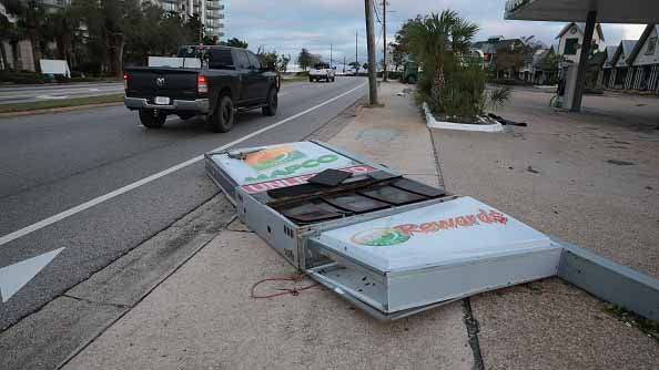 A gas station sign lies on the ground after Hurricane Isaias knocked it over as it passed through the area on October 10, 2026, in Destin, Florida. Hurricane Isaias made landfall as the season's first Atlantic hurricane with category two winds.