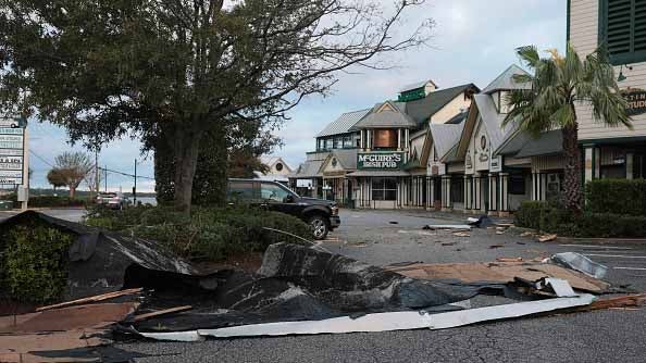 Roofing material lies on the ground after Hurricane Isaias tore it off as it passed through the area on October 10, 2026, in Destin, Florida. Hurricane Isaias made landfall as the season's first Atlantic hurricane with category two winds.