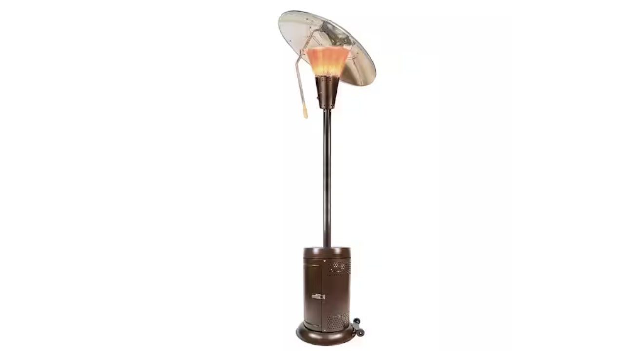 Tall bronze outdoor patio heater with lit flame and reflective dome hood on a wheeled base