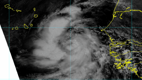Satellite image showing a swirling storm system with cloud coverage over ocean, with yellow coastline and island outlines