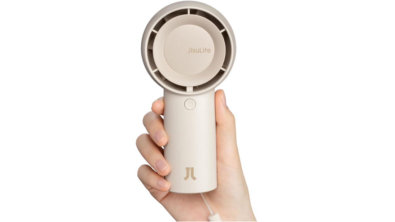Hand holding a beige JisuLife portable handheld fan with circular top and cylindrical handle against white background