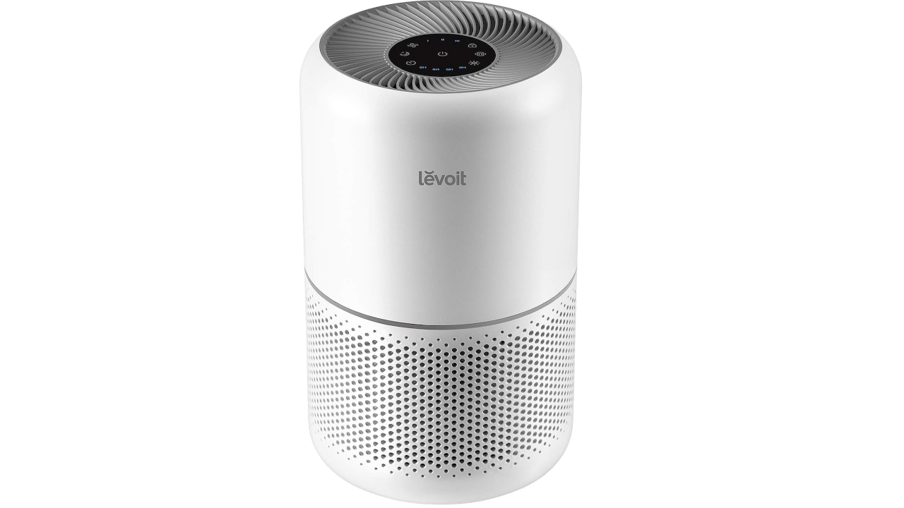 White Levoit air purifier with top control panel and perforated base on a white background