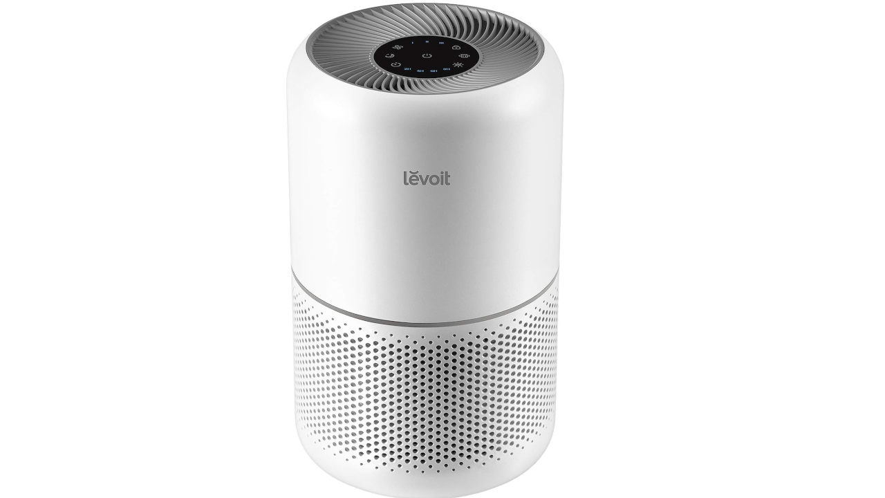 White cylindrical Levoit air purifier with circular top grille, digital display, and perforated ventilation holes on lower section