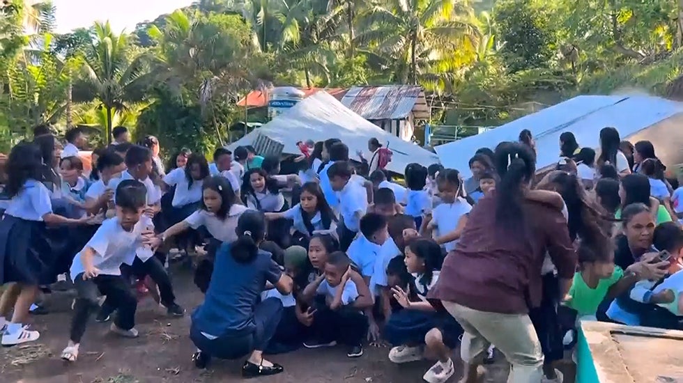 A large group of school children react to an earthquake
