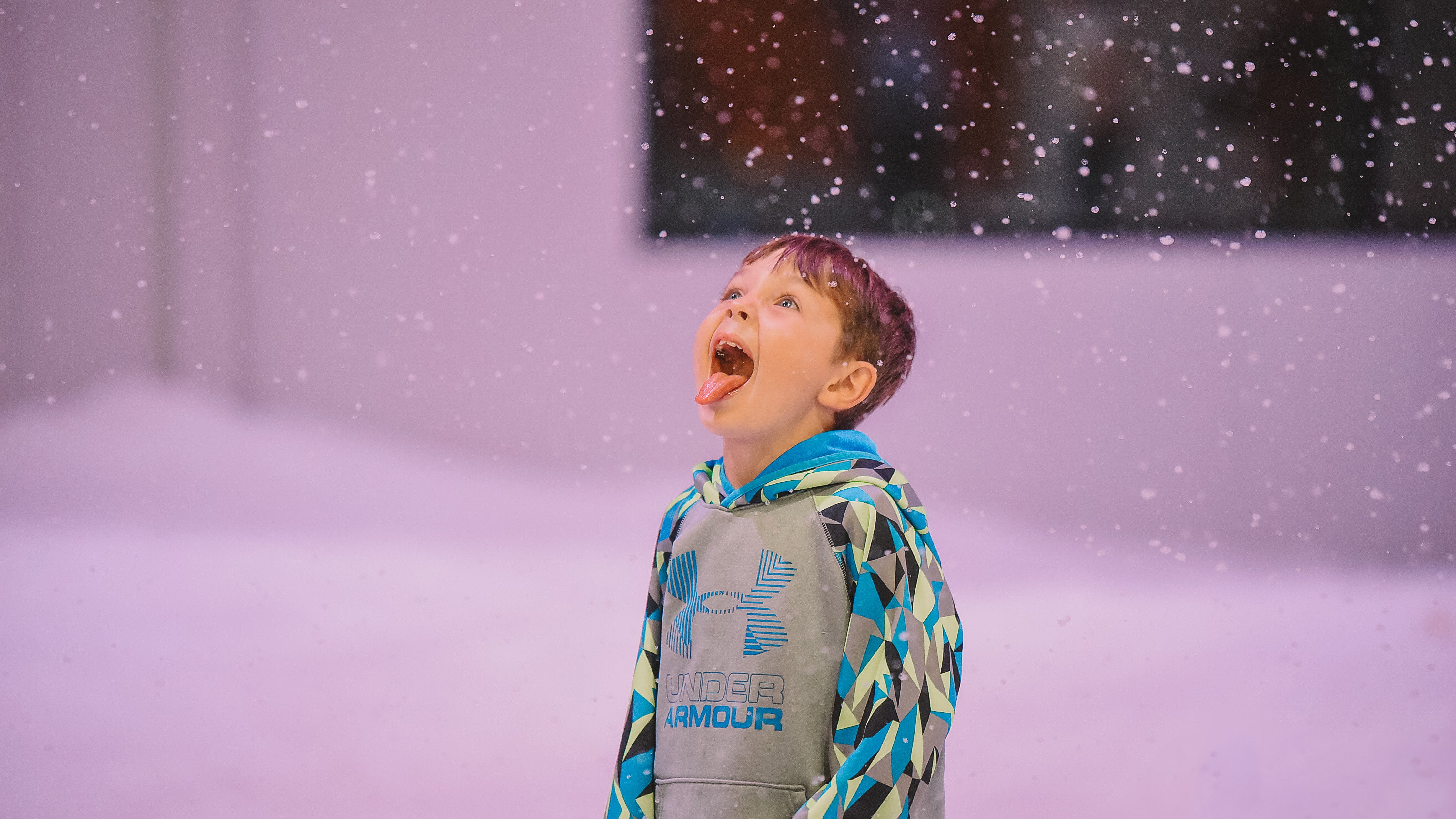 A child enjoying the falling snow at Pigeon Forge Snow in Tennessee.