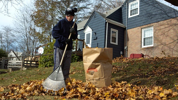 James Fletcher rakes leaves outside of his house in Portland on Sunday, November 12, 2017.