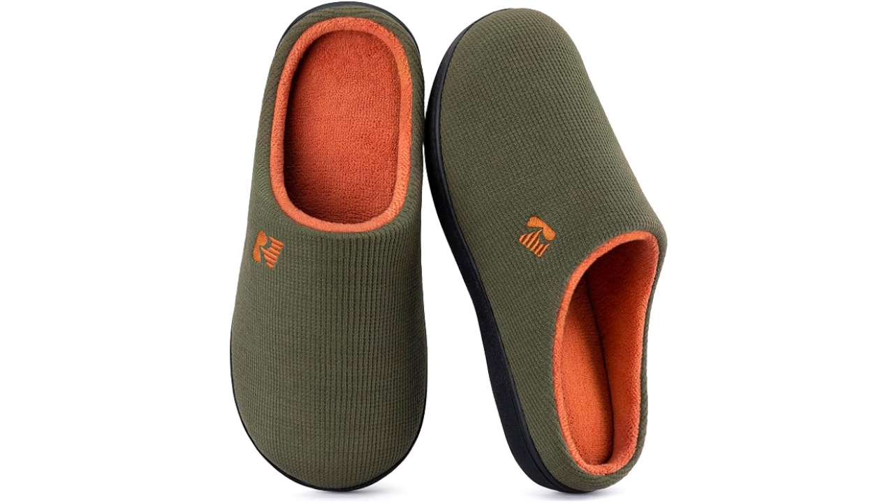 Pair of olive green slip-on slippers with orange fleece lining and black soles