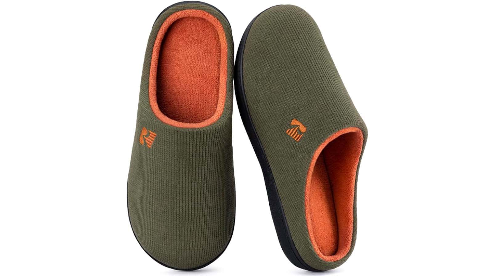 Pair of olive green slip-on slippers with orange fleece lining and black soles
