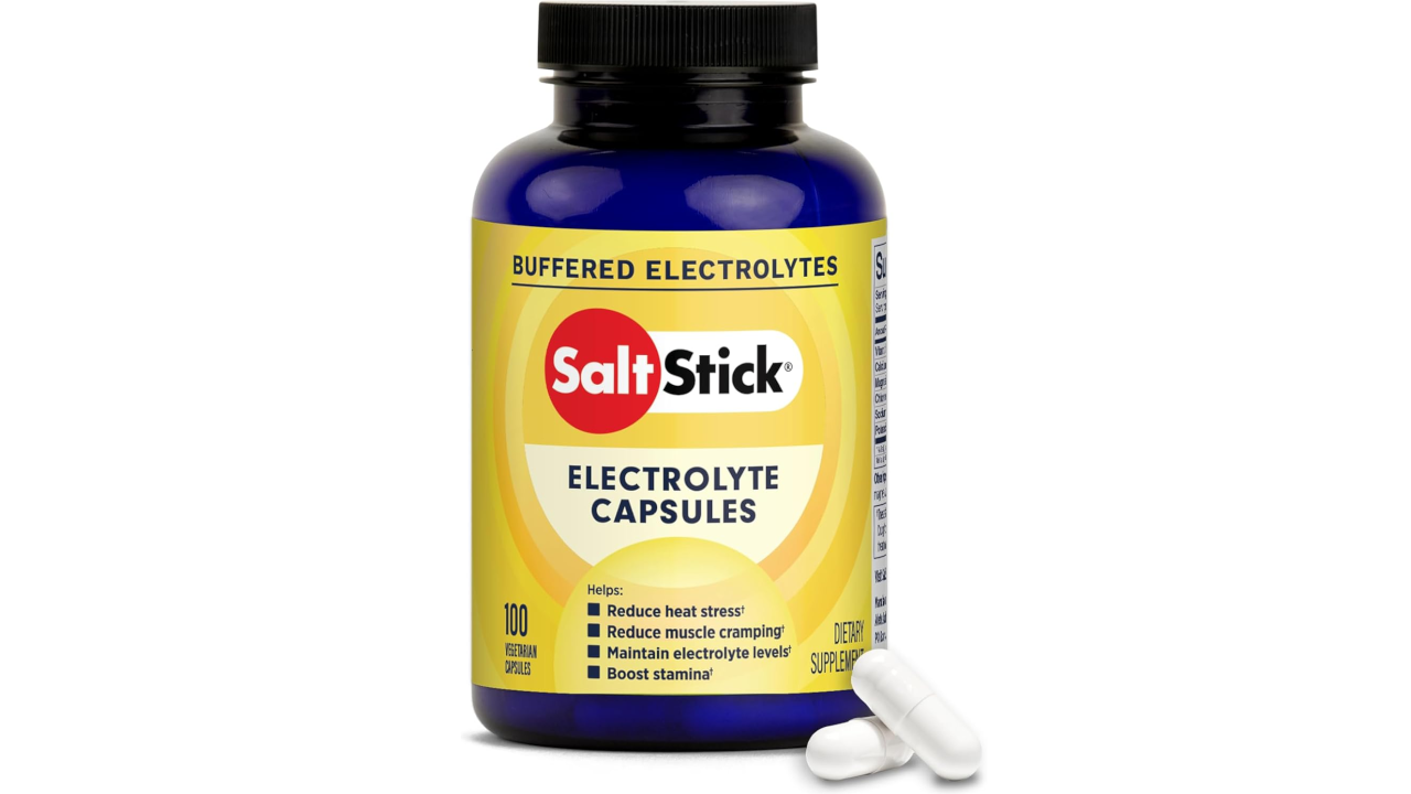 Blue bottle of SaltStick electrolyte capsules with two white capsules on a white background