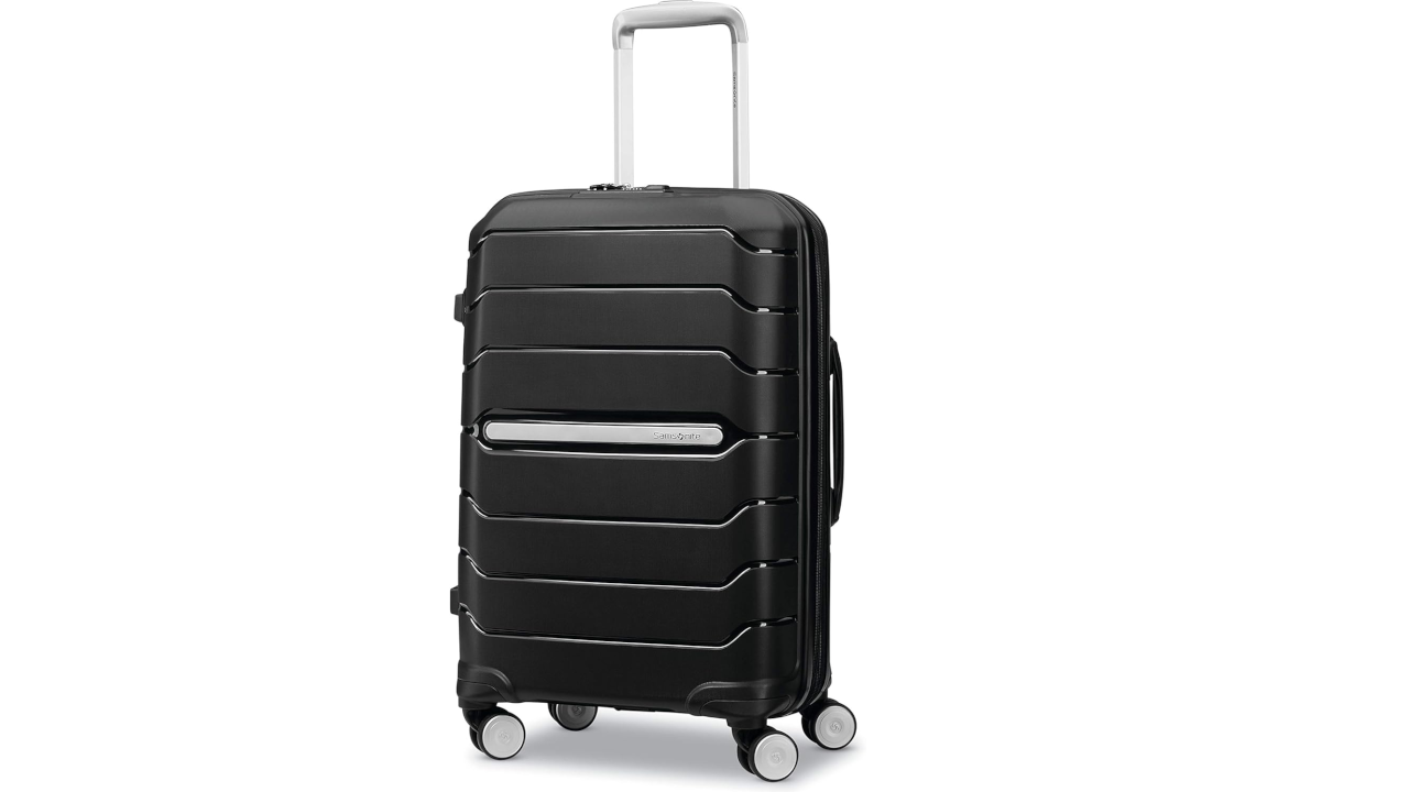 Black hard-shell suitcase with horizontal ridged design, silver telescoping handle, and four spinner wheels