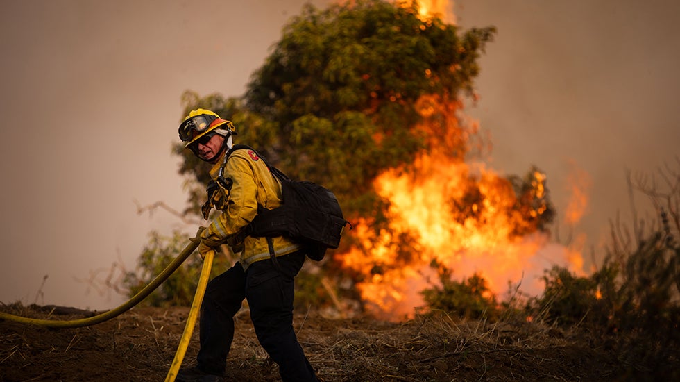 Fire crews battle the Sandy Fire Monday, May 18, 2026, in Simi Valley, Calif. (AP Photo/Ethan Swope)