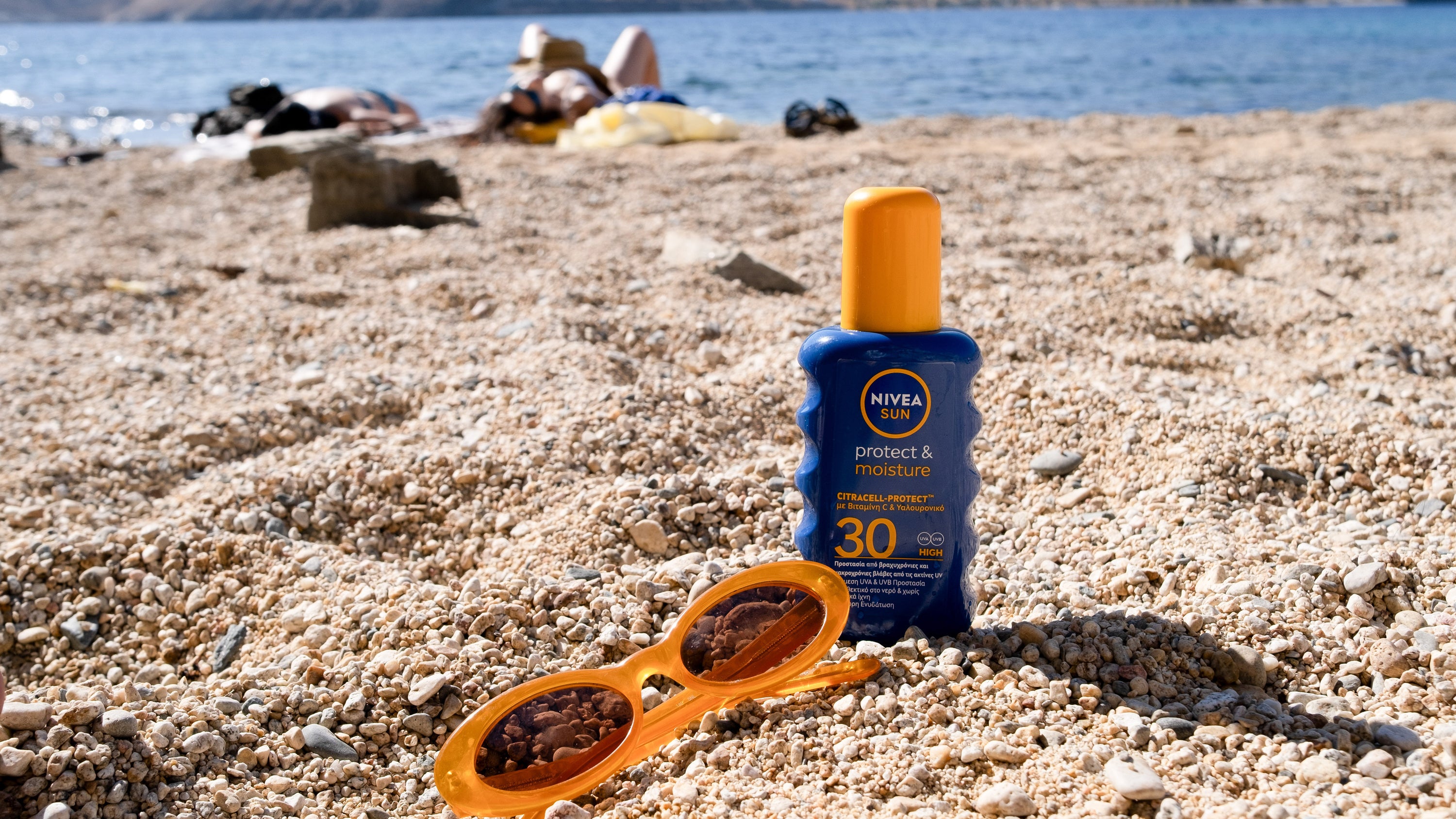 A bottle of sunscreen and sunglasses at Vagia beach on the island of Serifos, Greece, on July 6, 2025.
