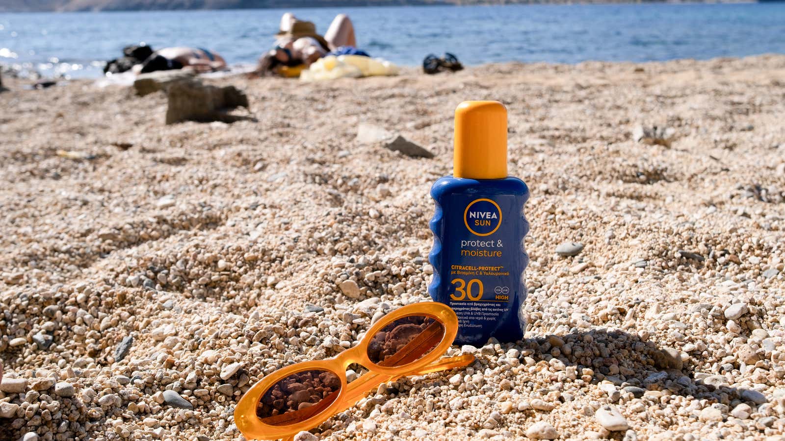 A bottle of sunscreen and sunglasses at Vagia beach on the island of Serifos, Greece, on July 6, 2025.