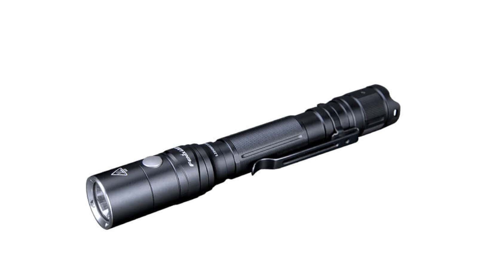 Black tactical flashlight with clip on a white background