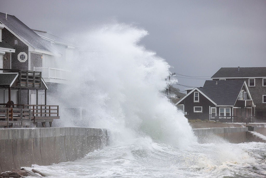 waves crash on houses