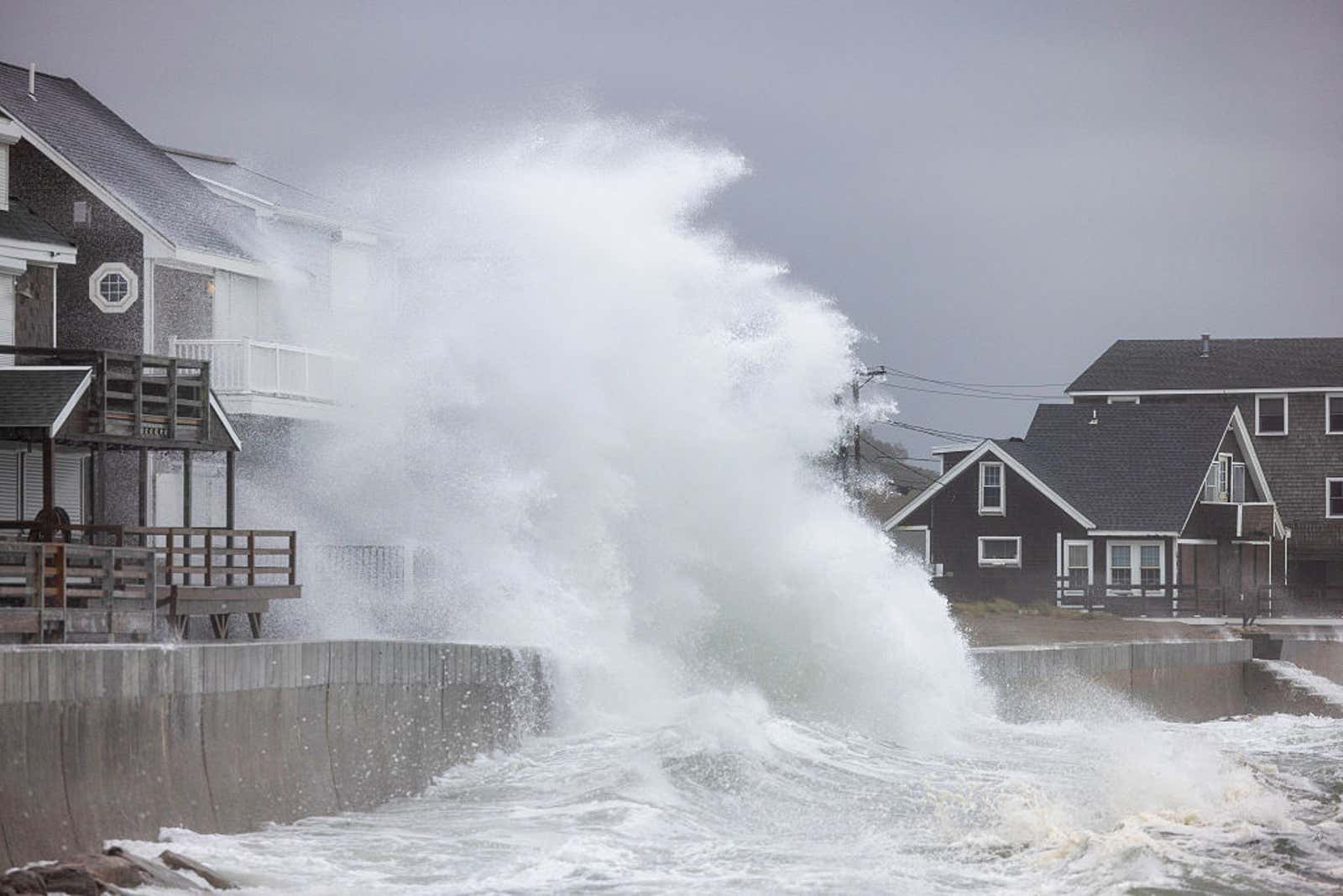 waves crash on houses