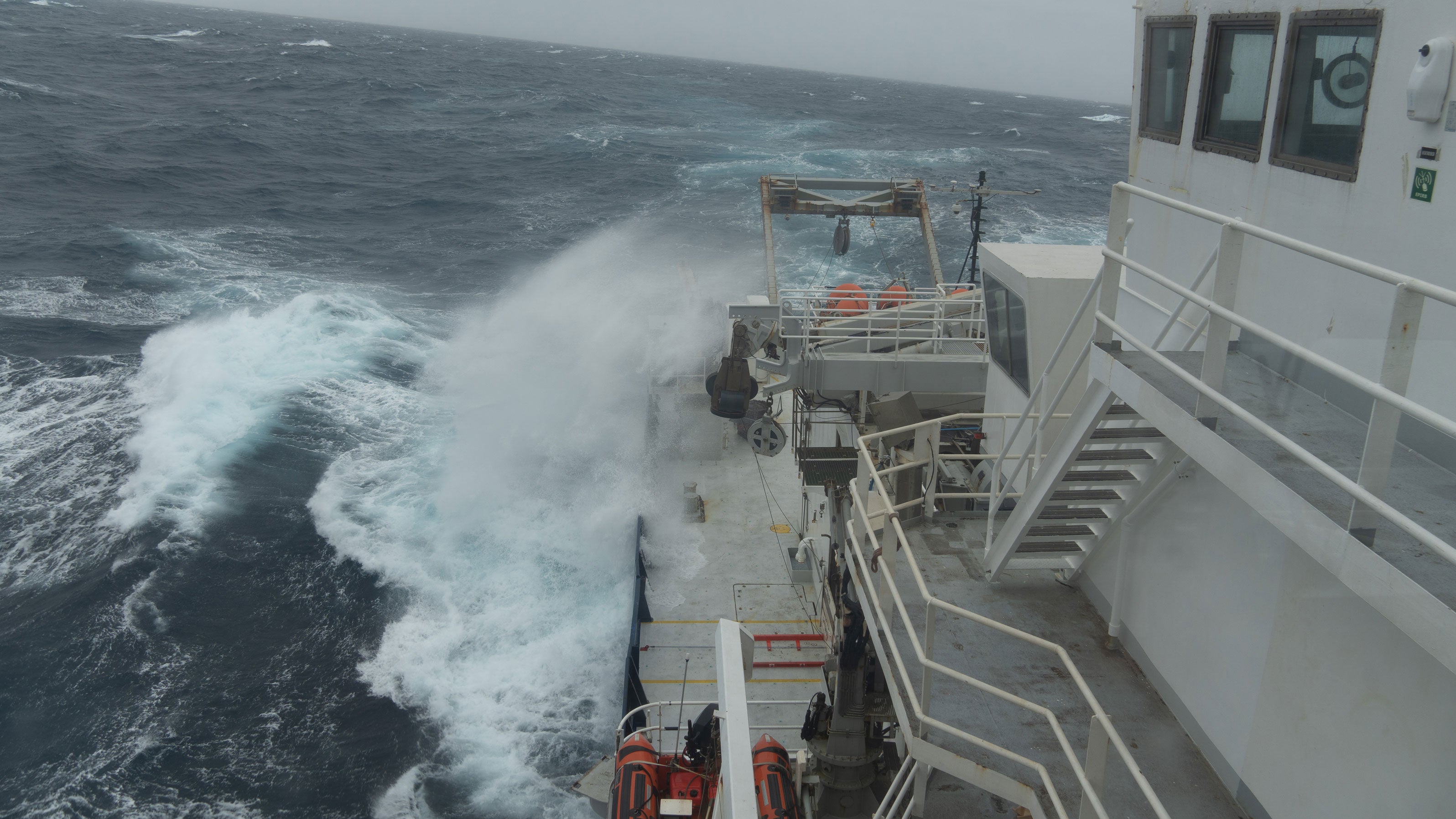 The research vessel facing rough Antarctic waters.