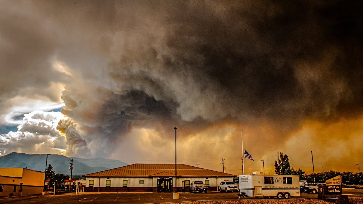 Thick smoke billows behind the Monticello Forest Service Office as the Babylon wildfire rages in Utah on July 6, 2026.