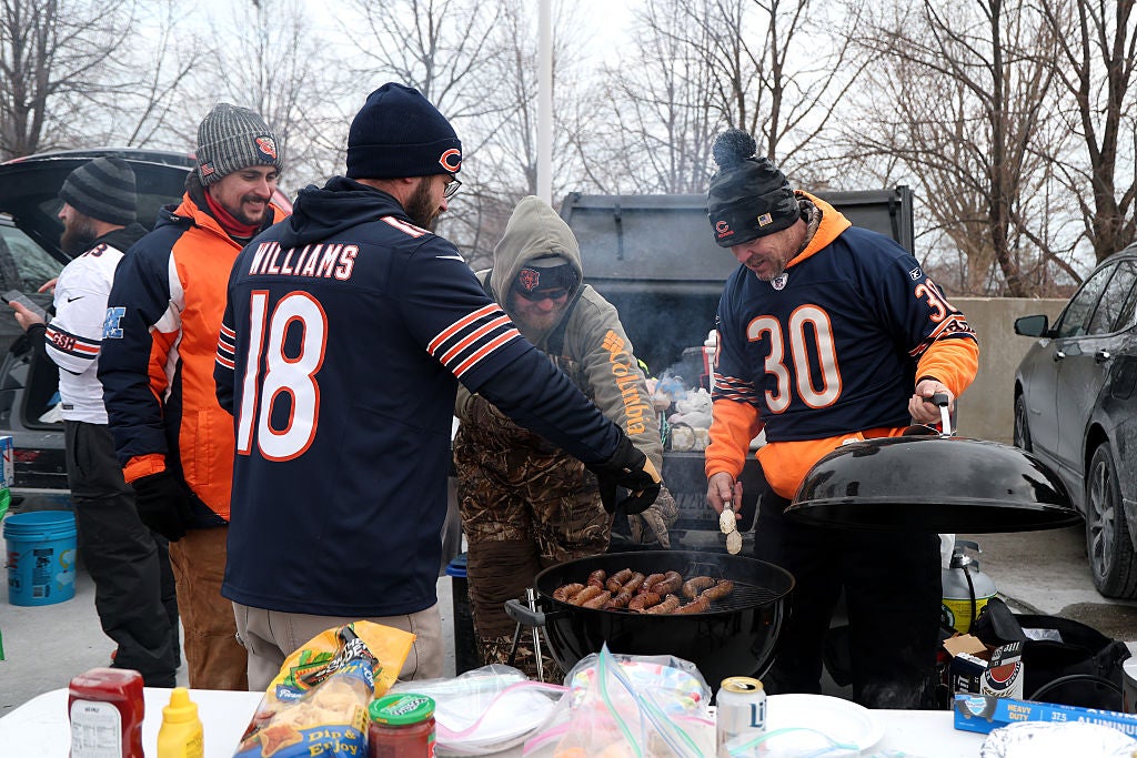 Fans tailgate and grill outside on a cold day