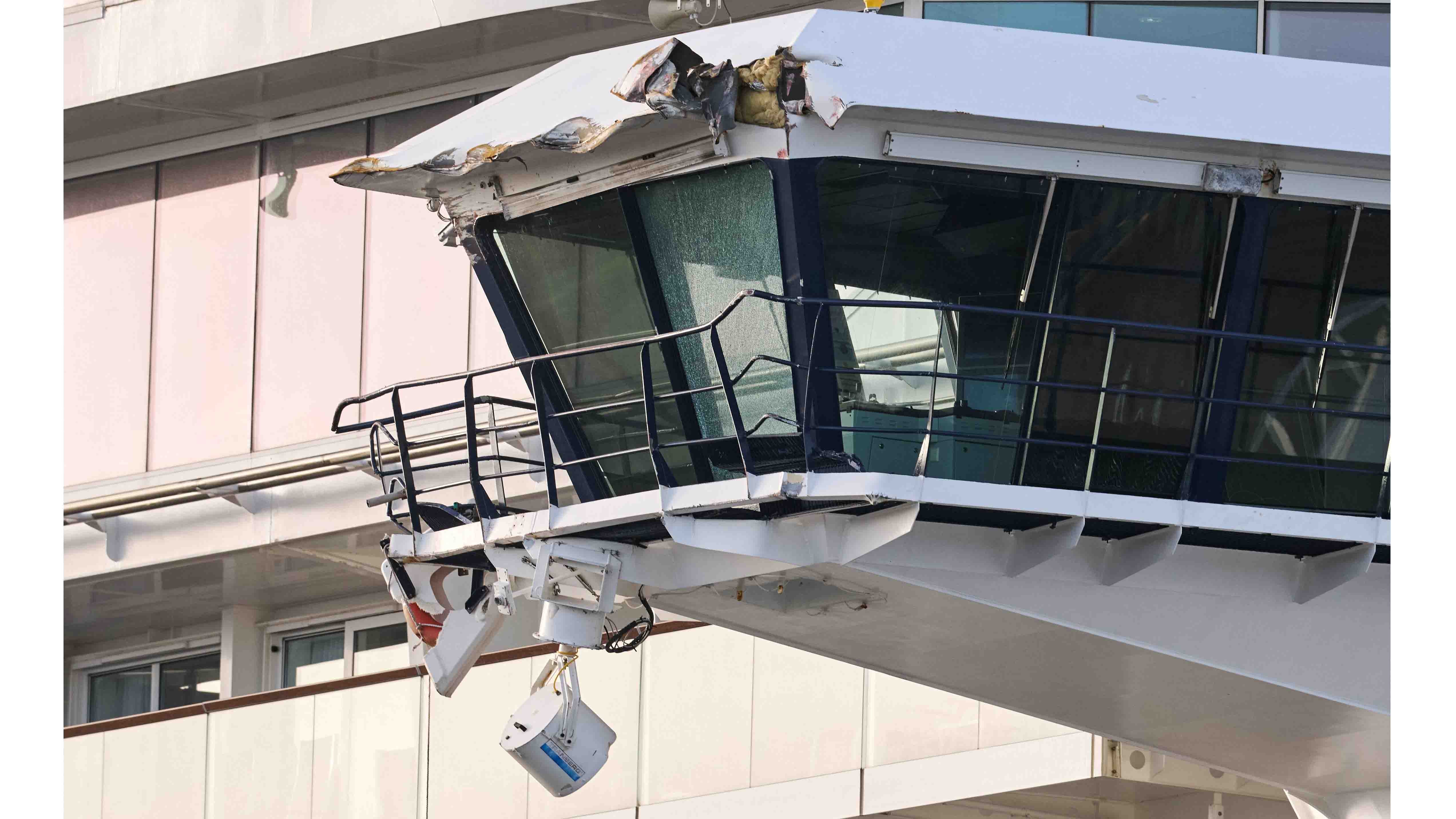 Close-up of a damaged cruise ship bridge wing with torn metal roof and exposed insulation