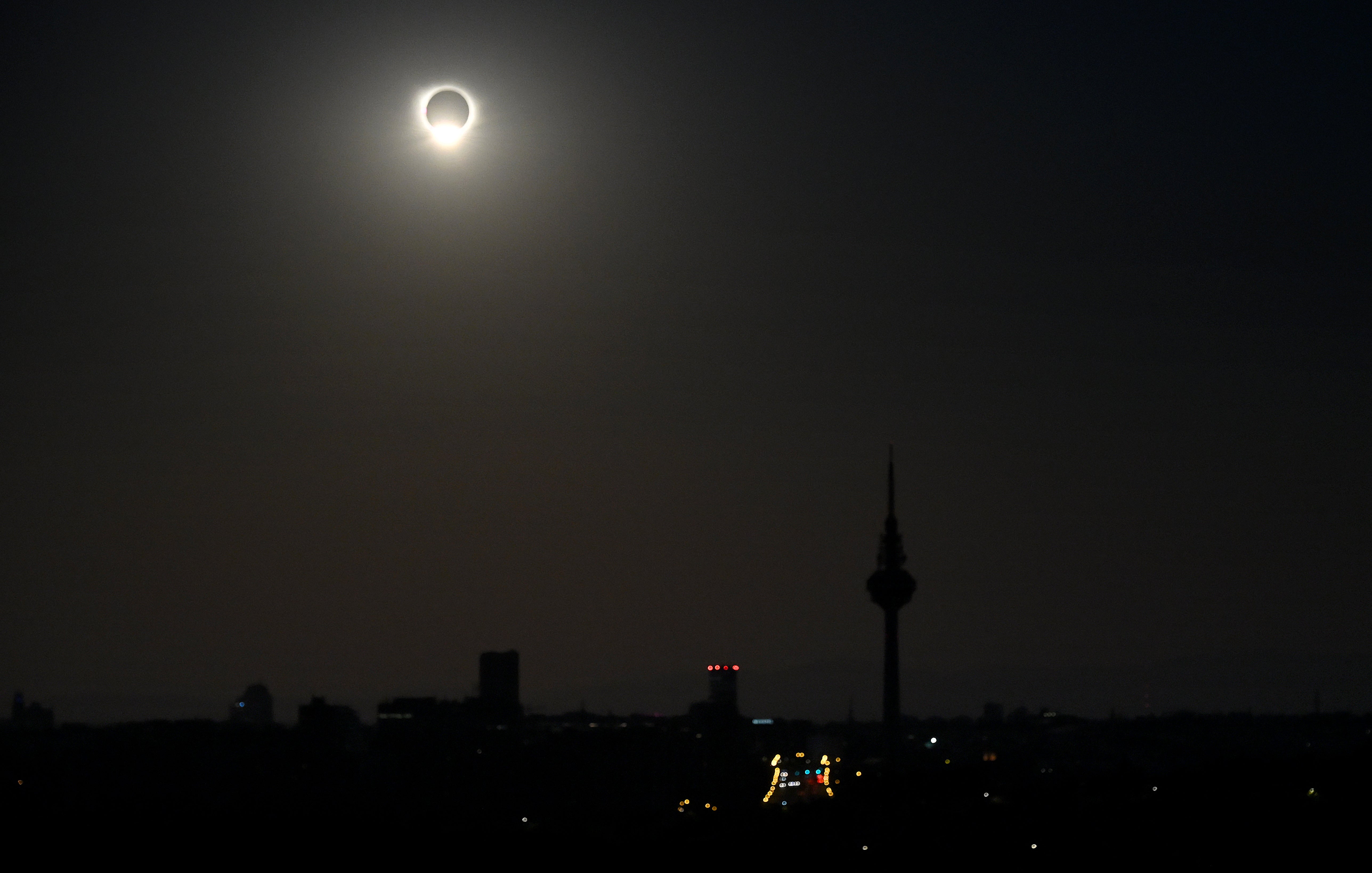 The sun is covered during a solar eclipse, surrounded by dark sky