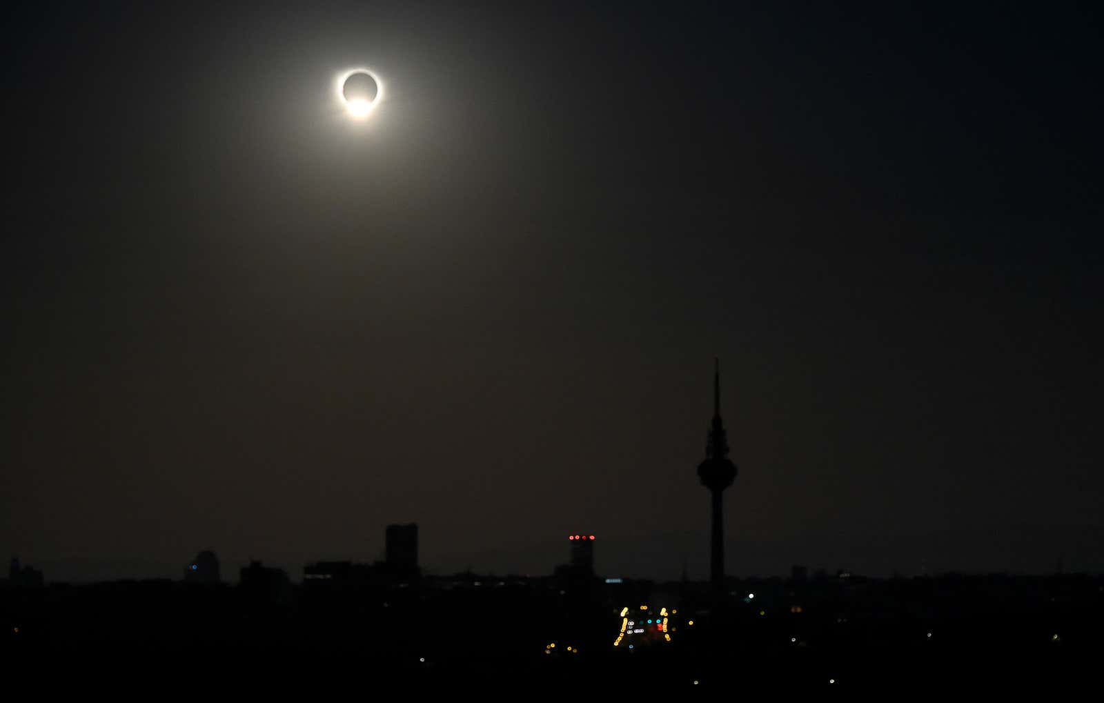The sun is covered during a solar eclipse, surrounded by dark sky