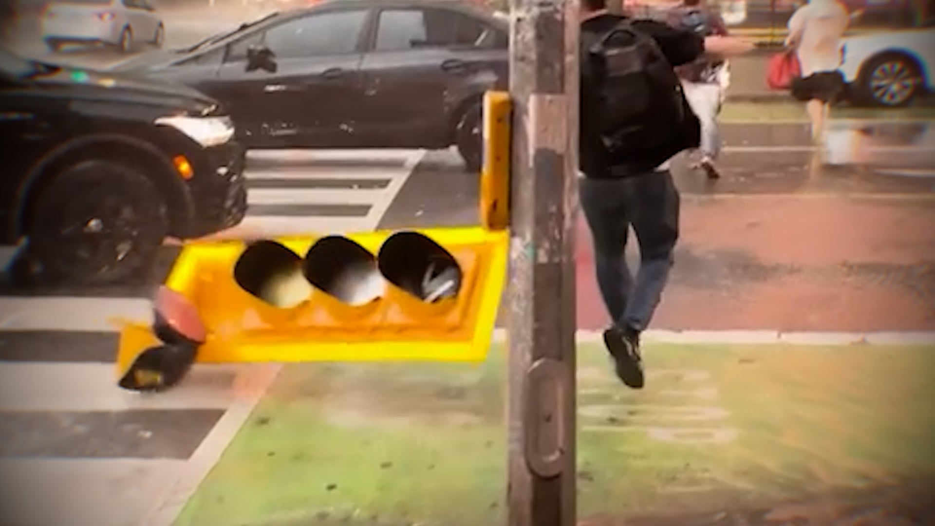 Flying traffic light barely misses pedestrian in wildly windy storm