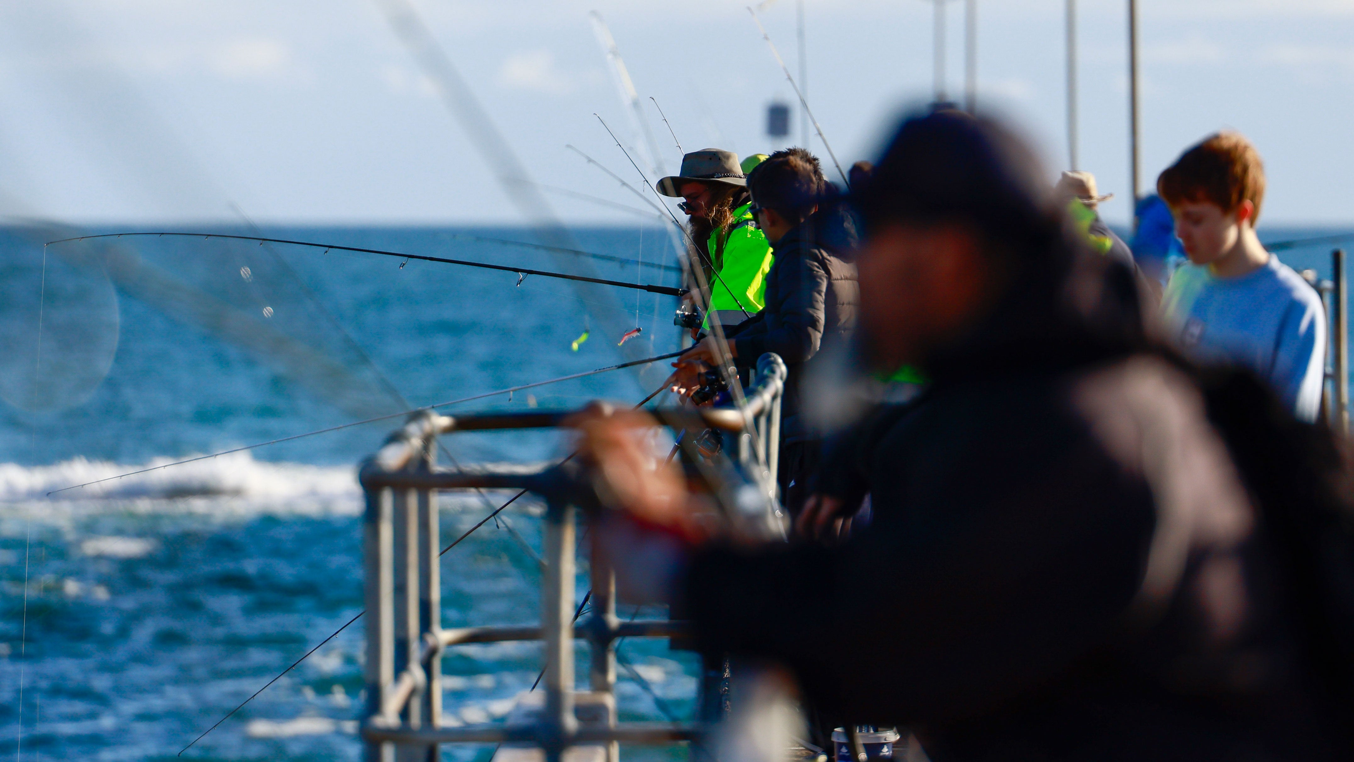 People fish from the jetty on June 6, 2026, in Port Noarlunga, Australia.