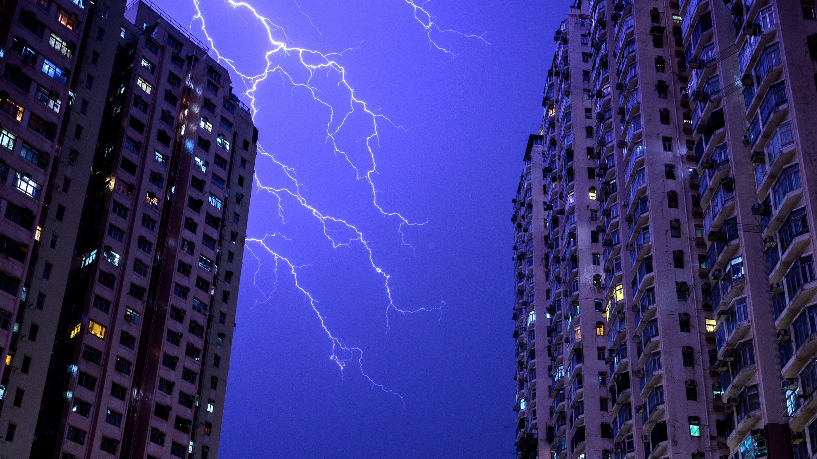 Lightning strikes illuminate the sky above a residential estate in the Tsuen Wan district of the New Territories in Hong Kong on June 6, 2026.