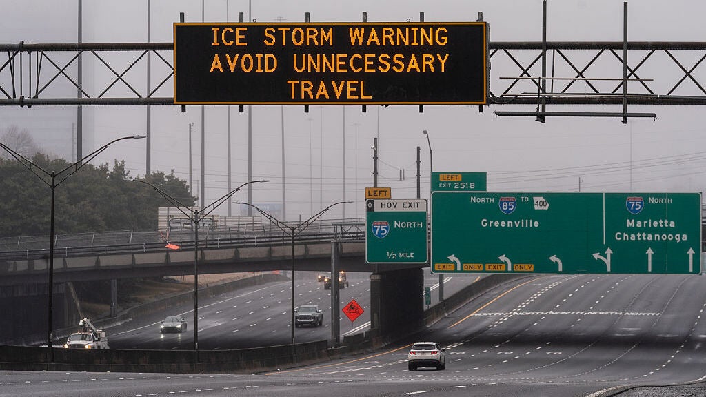 A sign warns drivers of an ice storm on January 25, 2026 in Atlanta, Georgia of a winter storm that is bringing frigid temperatures, ice and snow to nearly 200 million Americans. 