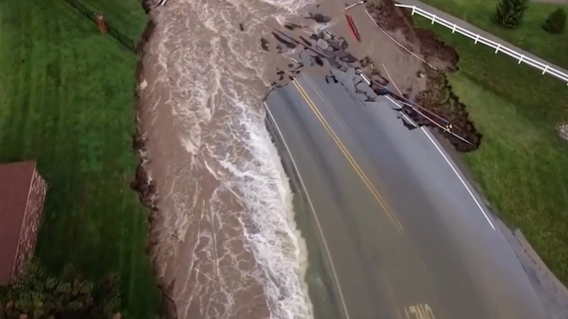 Record Indiana flooding collapses Indianapolis road, several dead