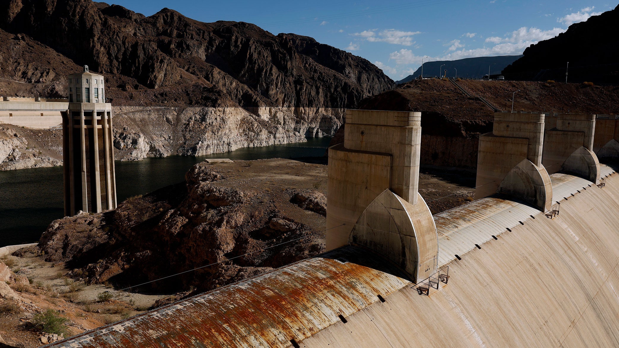 A water intake tower and a dry spillway at the Hoover Dam are seen next to a bleached "bathtub ring" on the banks of Lake Mead on Sept. 1, 2026 in Lake Mead National Recreation Area, Arizona. 