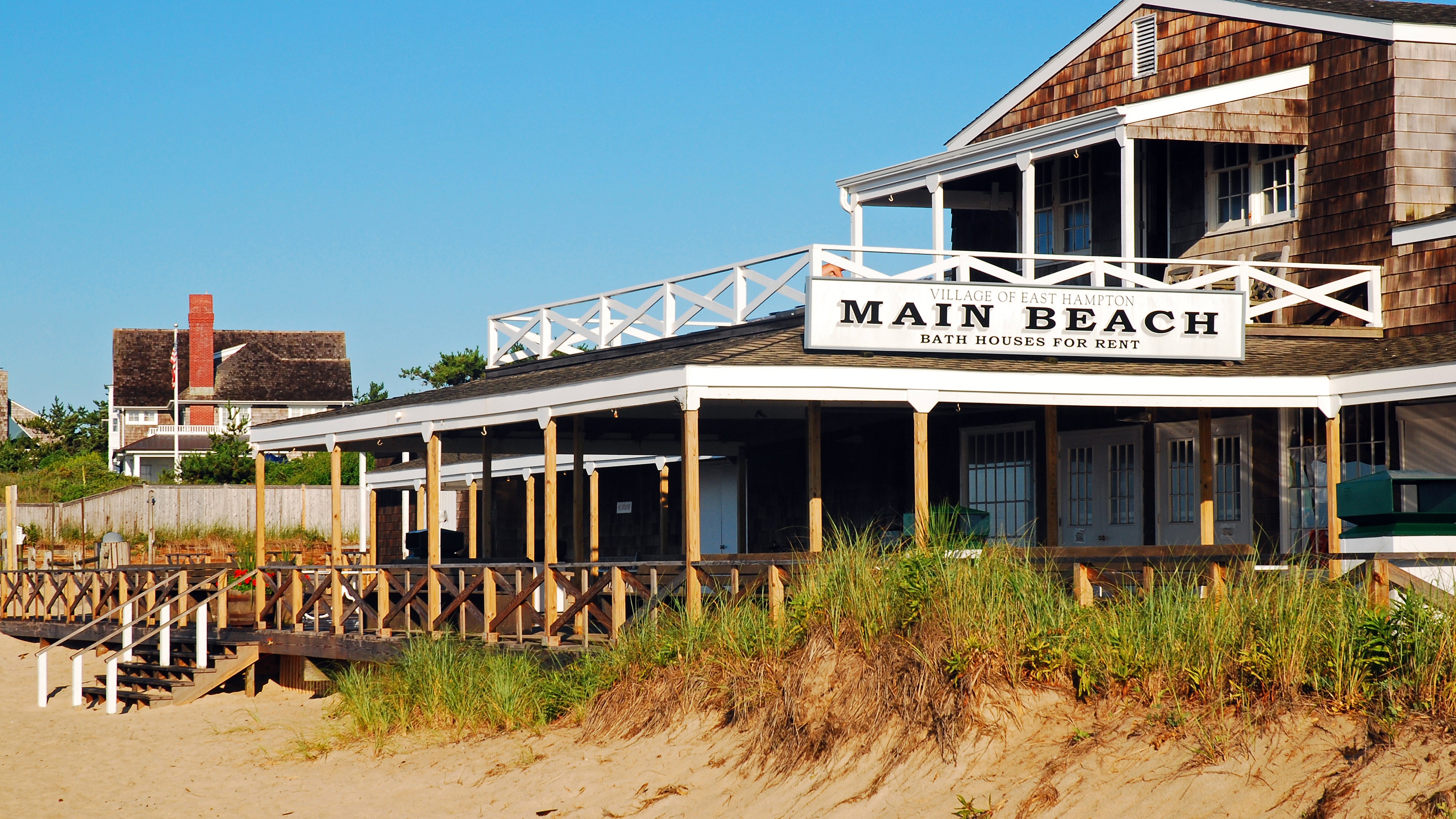 A historic shingled pavilion stands on the sand dunes on Main Beach in East Hampton New York.