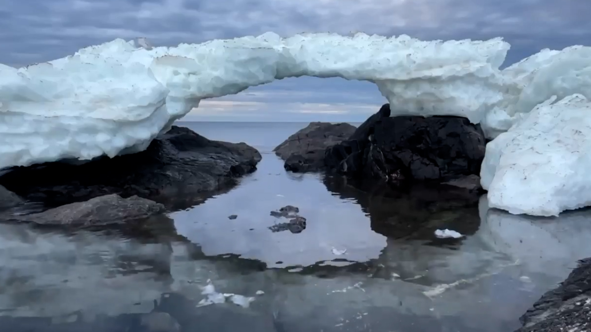 Winter's Last Stand: Ice Bridges Over Melted Lake