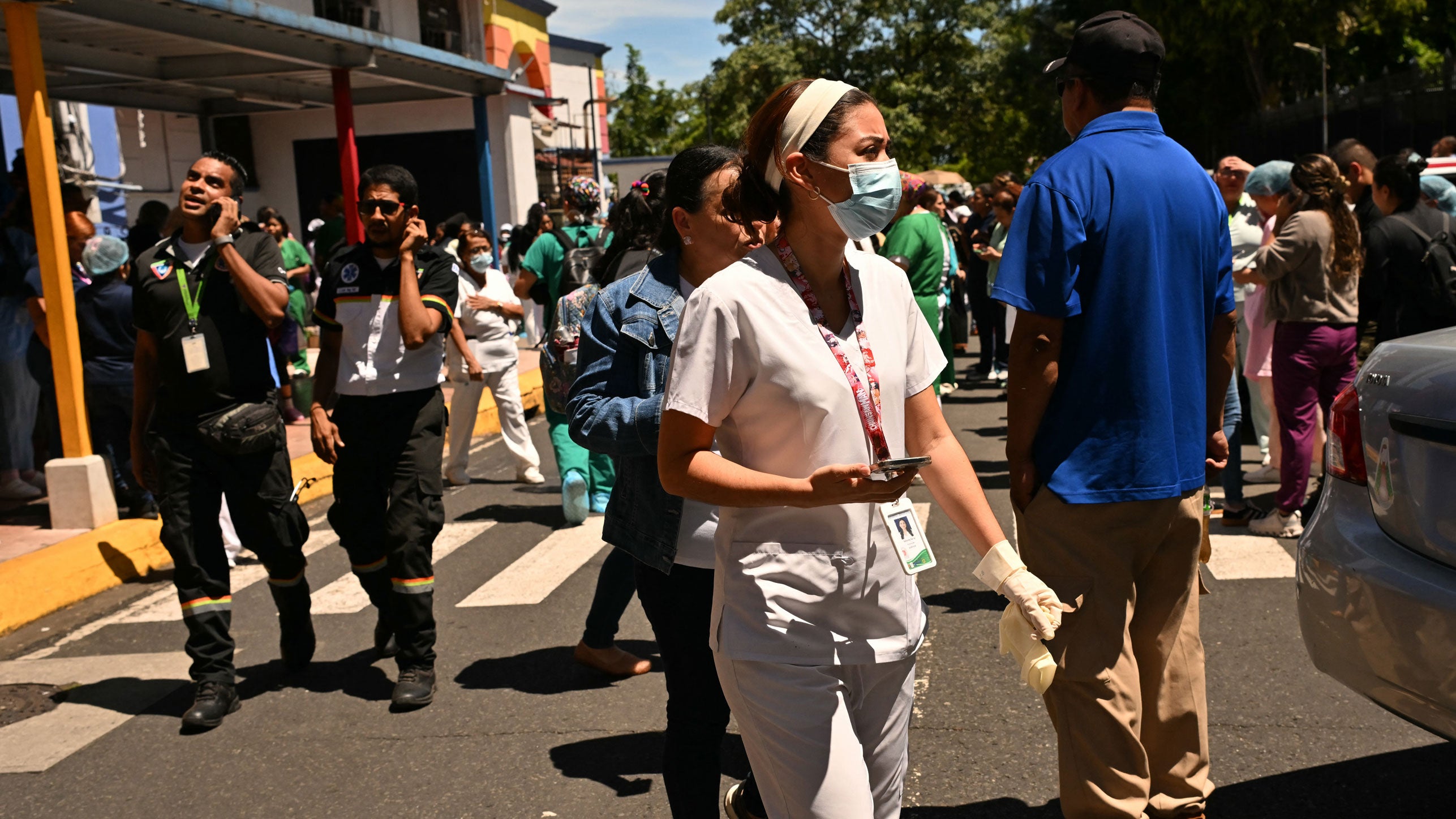People check their mobile phones outside the maternity ward of the Santo Tomas hospital, after a 7.6 magnitude earthquake hit the country, in Panama City on Oct. 9, 2026. A severe magnitude 7.6 earthquake shook Panama, according to the U.S. Geological Survey (USGS), sparking panic in the capital, though no casualties or damage have been reported so far.