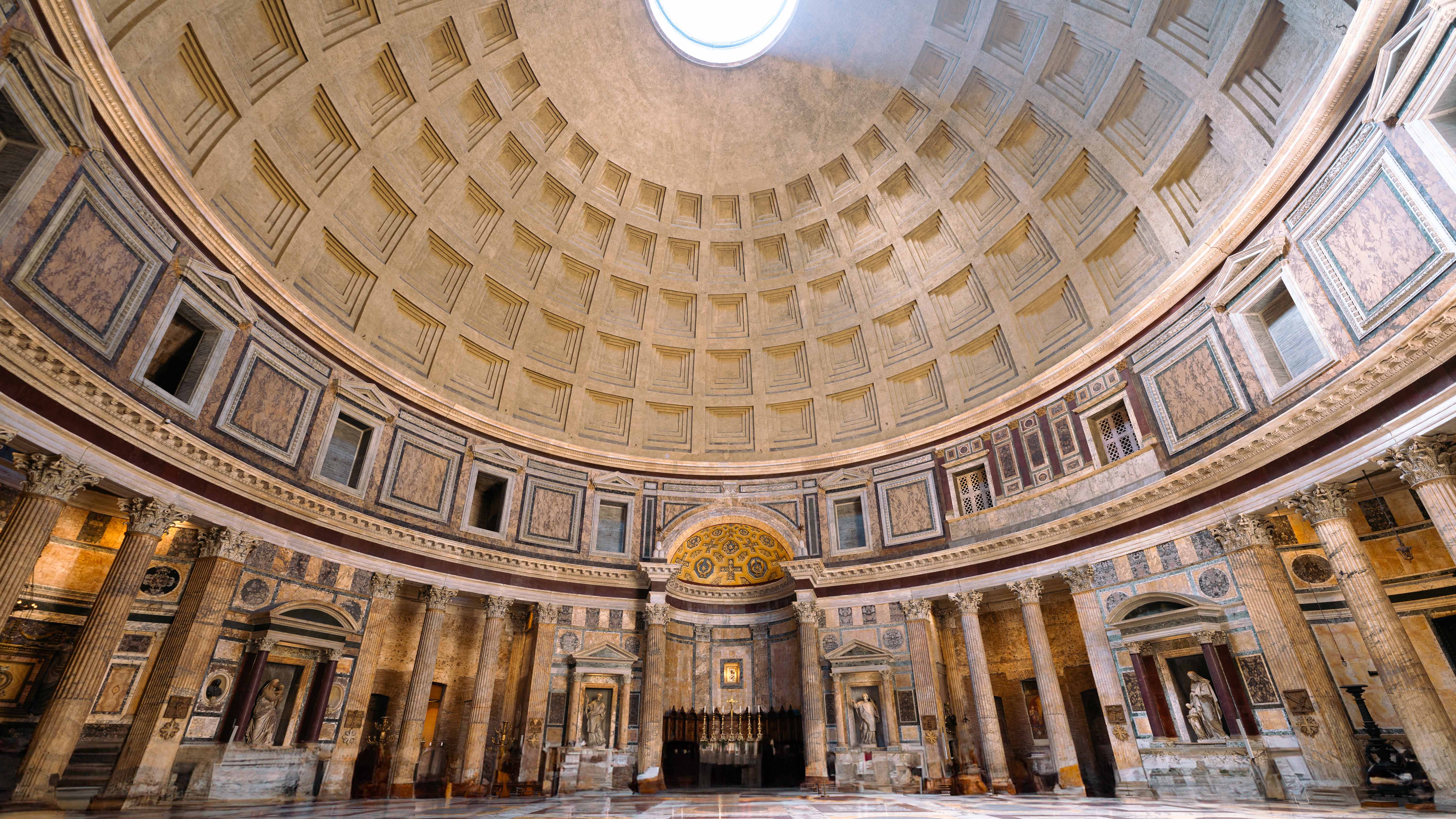 Interior of the Pantheon in Rome, showing its coffered dome, oculus, and marble columns.