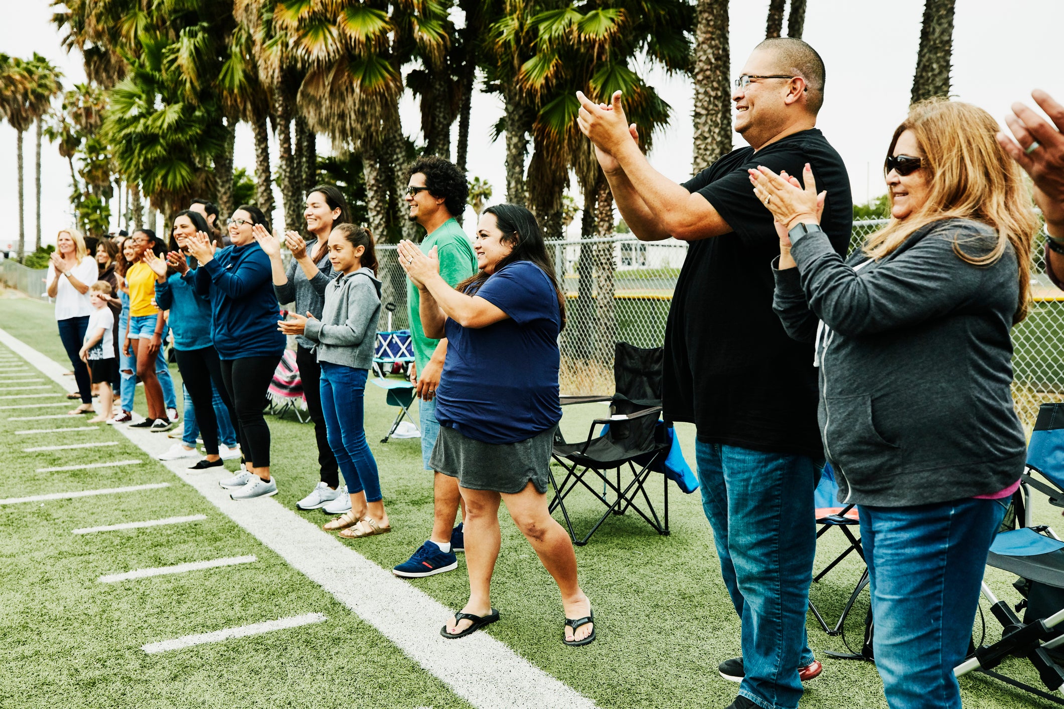 Parents and fans cheering on the sideline 