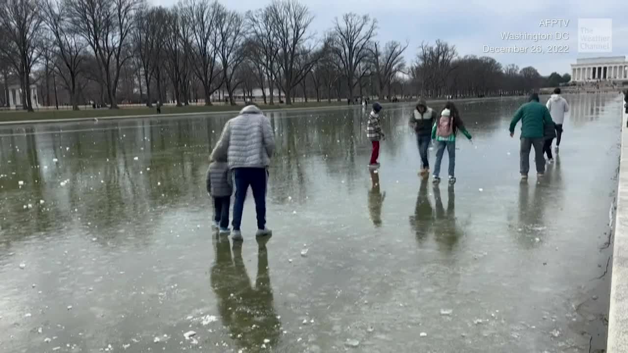 People Walk On Frozen Washington D.C. Reflecting Pool