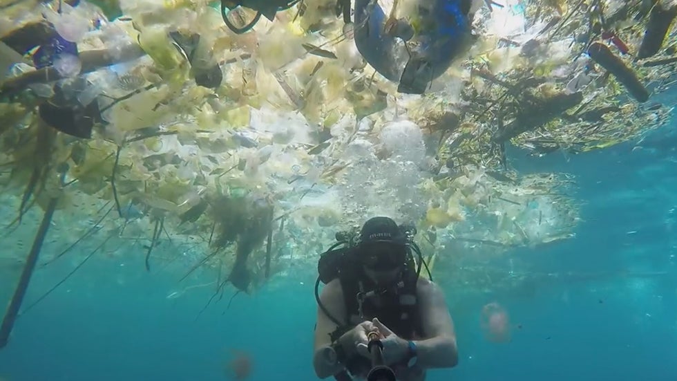 Scuba Diver Swims Through Sea of Plastic Off Coast of Bali