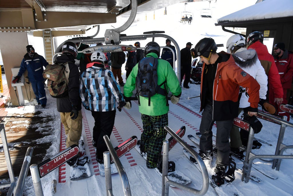 Skiers and snowboarders enter the gate to head up on the Colorado Super Chair lift on Peak 8 at the Breckenridge Ski resort November 23, 2019.