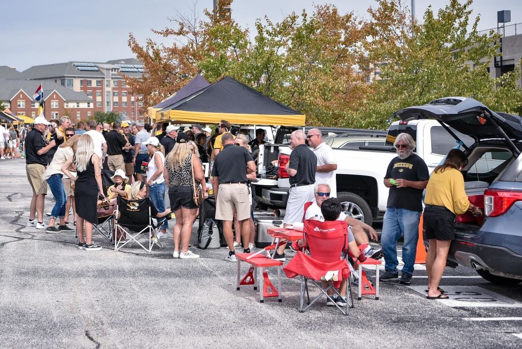 Fans make the most of a game day, tailgating outside. Be prepared to brace the sweltering heat. 