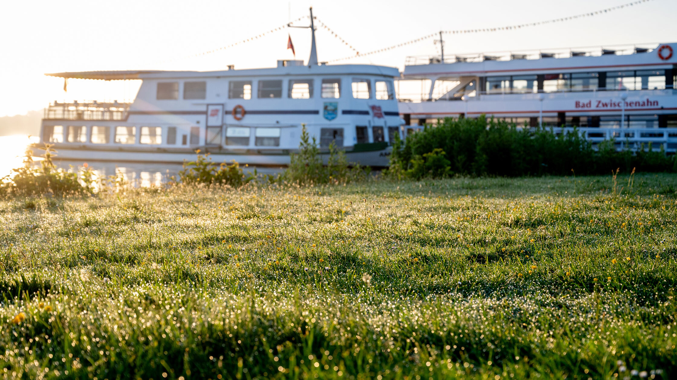 Two excursion boats from the Ekkenga shipping company are moored in the morning sun at a jetty in the spa gardens on May 30, 2026, in Lower Saxony, Bad Zwischenahn.