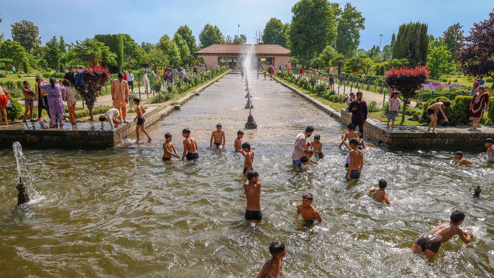 Kashmiri boys swim in a fountain pool to cool off on a hot summer day at a Mughal garden in Srinagar, Jammu and Kashmir, on May 29, 2026.
