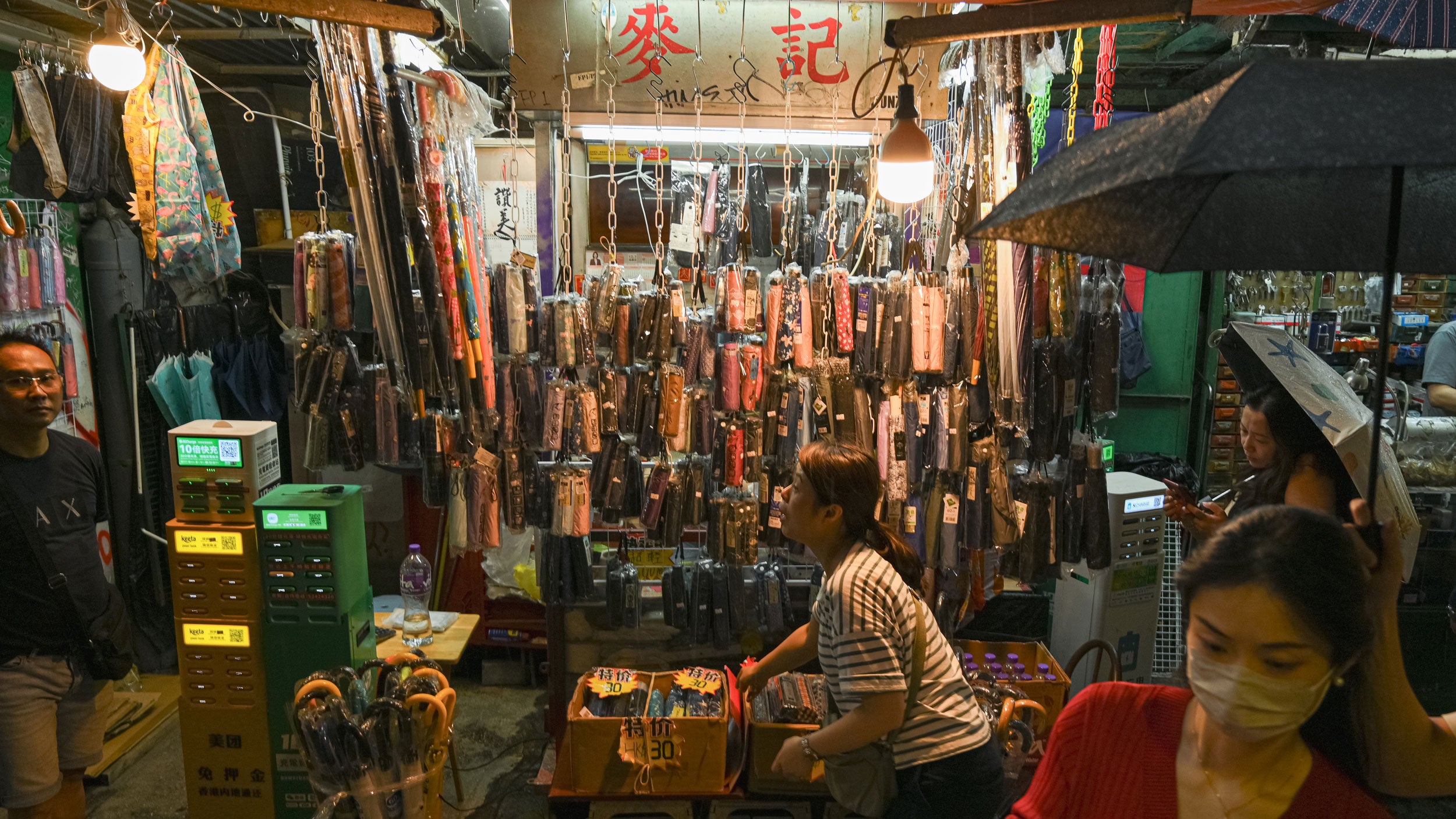 A local vendor displays umbrellas for sale during a rainy day in the Central District on May 14, 2026 in Hong Kong, China.