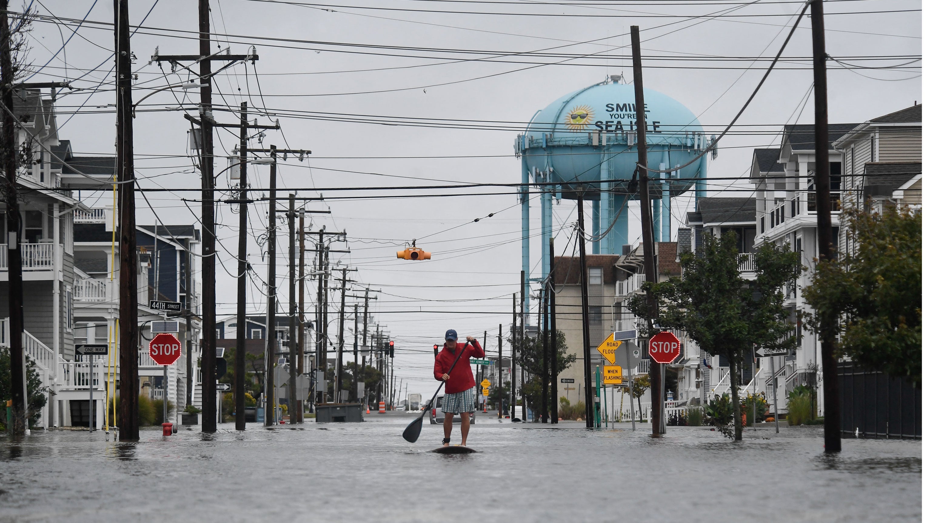 A man paddleboards along a flooded street following heavy rainfall in Sea Isle City, New Jersey, U.S., on Sept. 27, 2026. New York, Boston and Philadelphia were all in the firing line of the nor'easter which brought flooding, downed trees and damaged power lines.